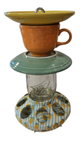 This is a handcrafted Birdfeeder made from a Fiesta Fiestware Cup and two saucers. It includes a glass jar to hold birdseed and either a plastic or metal base for the birds to land and feast. The top saucer is also perfect to hold grape jam or orange slices to feed your local orioles. Please see item description for specific cup and saucer color, jar color and base type. Crafted, Fiesta Second Life
