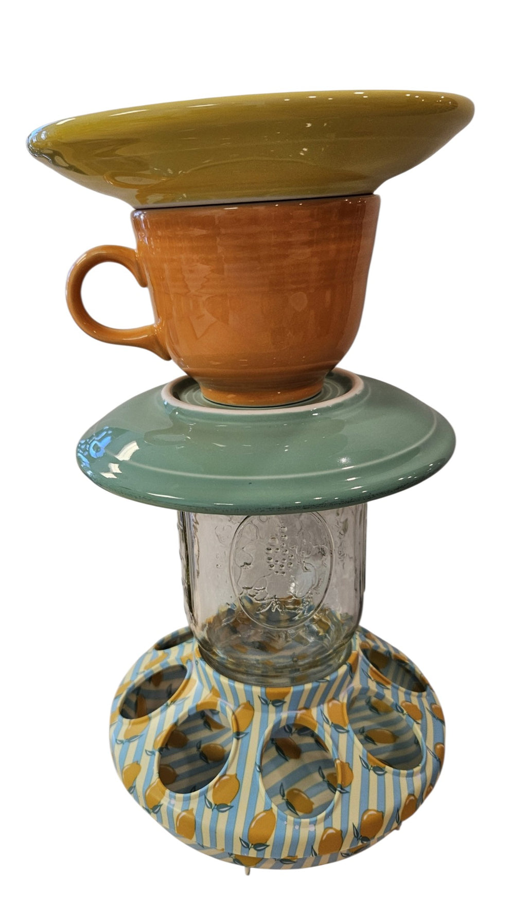 This is a handcrafted Birdfeeder made from a Fiesta Fiestware Cup and two saucers. It includes a glass jar to hold birdseed and either a plastic or metal base for the birds to land and feast. The top saucer is also perfect to hold grape jam or orange slices to feed your local orioles. Please see item description for specific cup and saucer color, jar color and base type. Crafted, Fiesta Second Life
