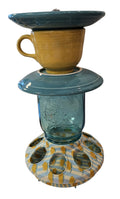 This is a handcrafted Birdfeeder made from a Fiesta Fiestware Cup and two saucers. It includes a glass jar to hold birdseed and either a plastic or metal base for the birds to land and feast. The top saucer is also perfect to hold grape jam or orange slices to feed your local orioles. Please see item description for specific cup and saucer color, jar color and base type. Crafted, Fiesta Second Life
