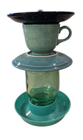 This is a handcrafted Birdfeeder made from a Fiesta Fiestware Cup and two saucers. It includes a glass jar to hold birdseed and either a plastic or metal base for the birds to land and feast. The top saucer is also perfect to hold grape jam or orange slices to feed your local orioles. Please see item description for specific cup and saucer color, jar color and base type. Crafted, Fiesta Second Life
