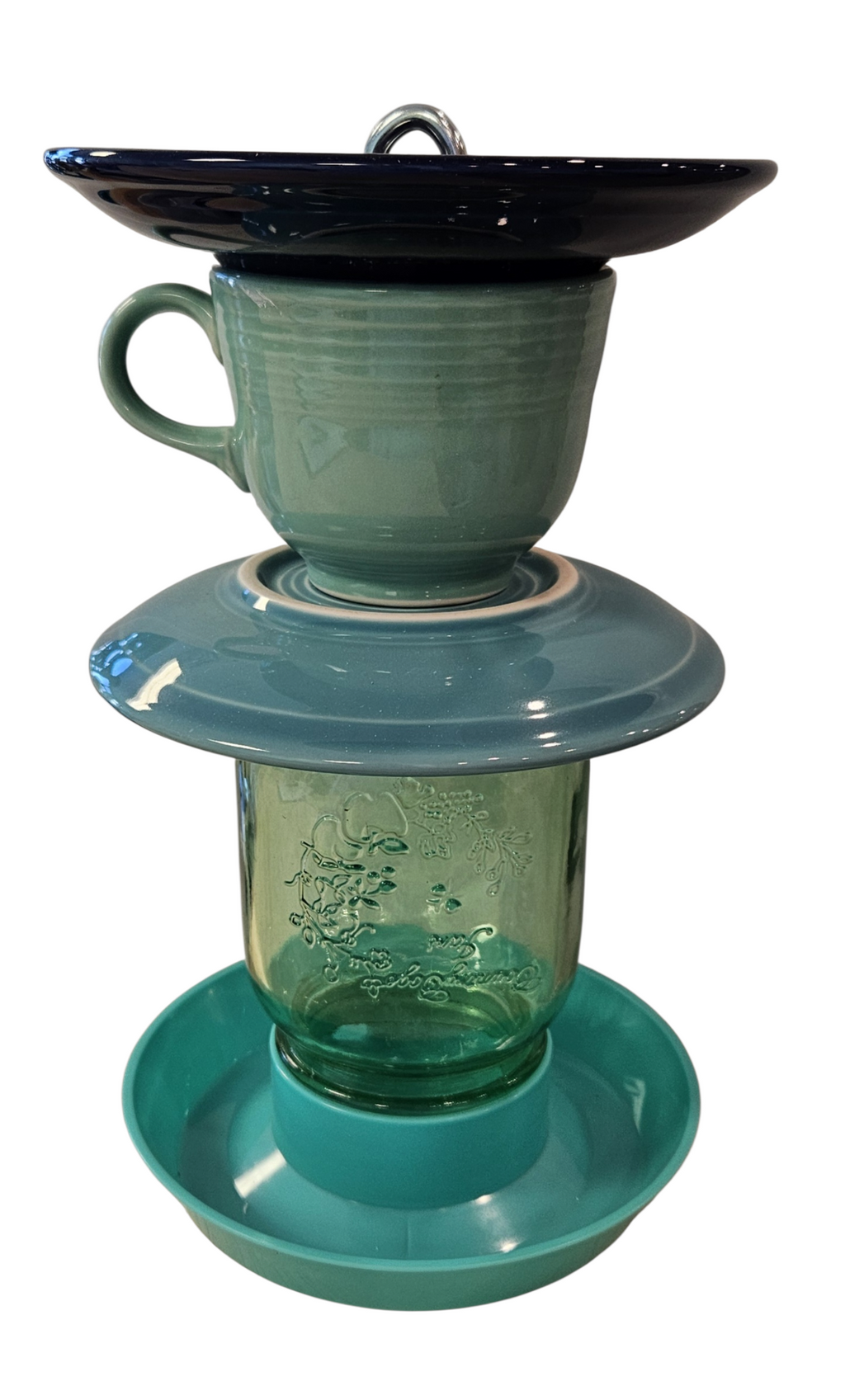 This is a handcrafted Birdfeeder made from a Fiesta Fiestware Cup and two saucers. It includes a glass jar to hold birdseed and either a plastic or metal base for the birds to land and feast. The top saucer is also perfect to hold grape jam or orange slices to feed your local orioles. Please see item description for specific cup and saucer color, jar color and base type. Crafted, Fiesta Second Life
