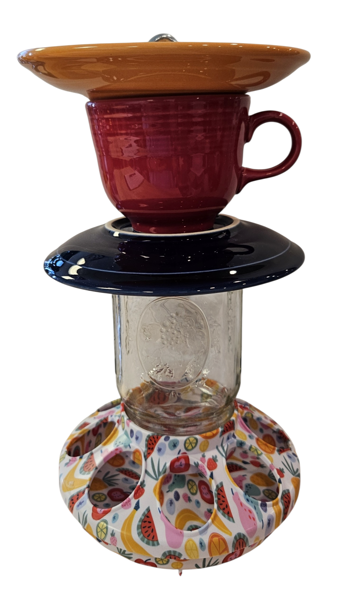 This is a handcrafted Birdfeeder made from a Fiesta Fiestware Cup and two saucers. It includes a glass jar to hold birdseed and either a plastic or metal base for the birds to land and feast. The top saucer is also perfect to hold grape jam or orange slices to feed your local orioles. Please see item description for specific cup and saucer color, jar color and base type. Crafted, Fiesta Second Life
