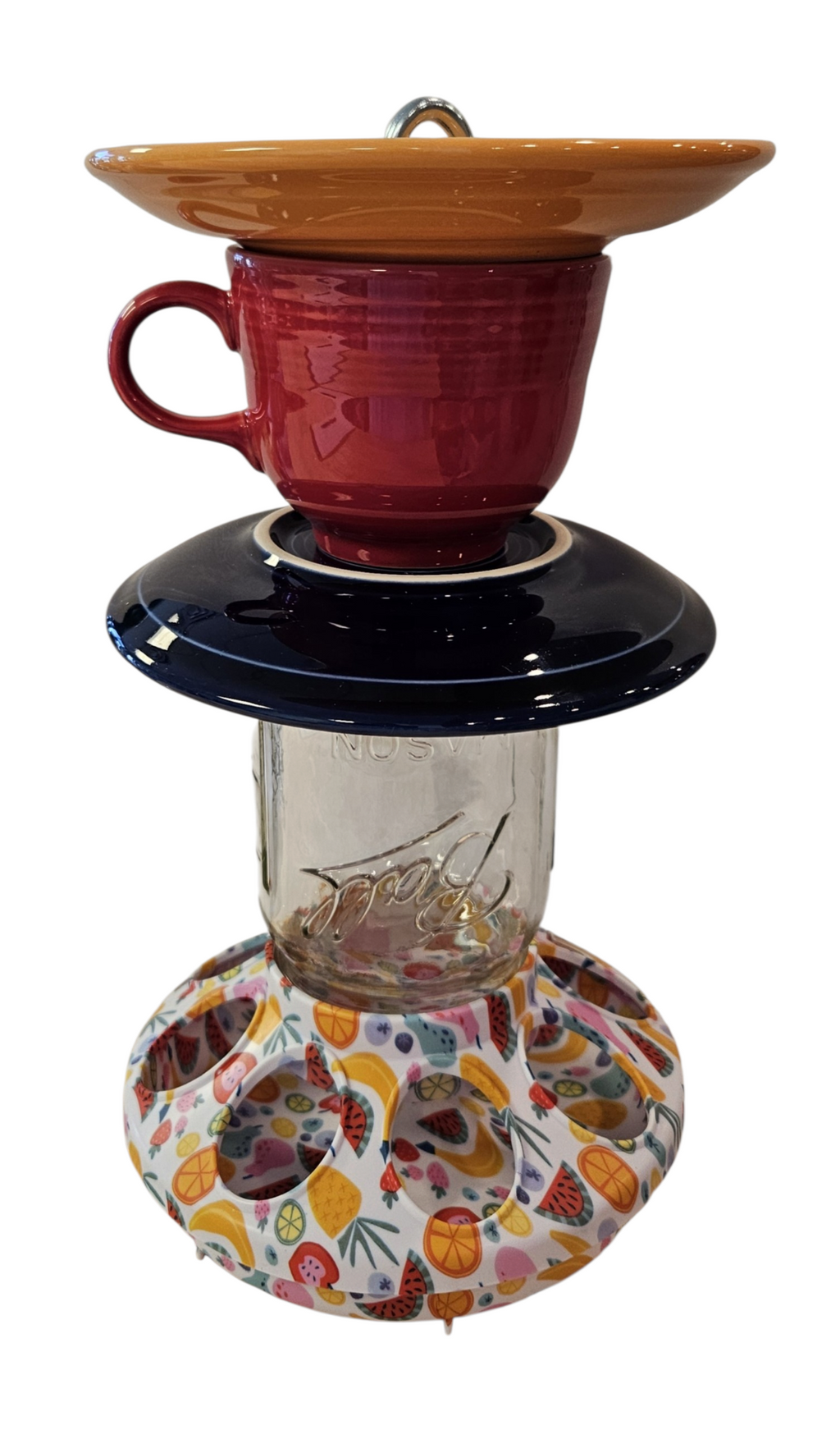 This is a handcrafted Birdfeeder made from a Fiesta Fiestware Cup and two saucers. It includes a glass jar to hold birdseed and either a plastic or metal base for the birds to land and feast. The top saucer is also perfect to hold grape jam or orange slices to feed your local orioles. Please see item description for specific cup and saucer color, jar color and base type. Crafted, Fiesta Second Life
