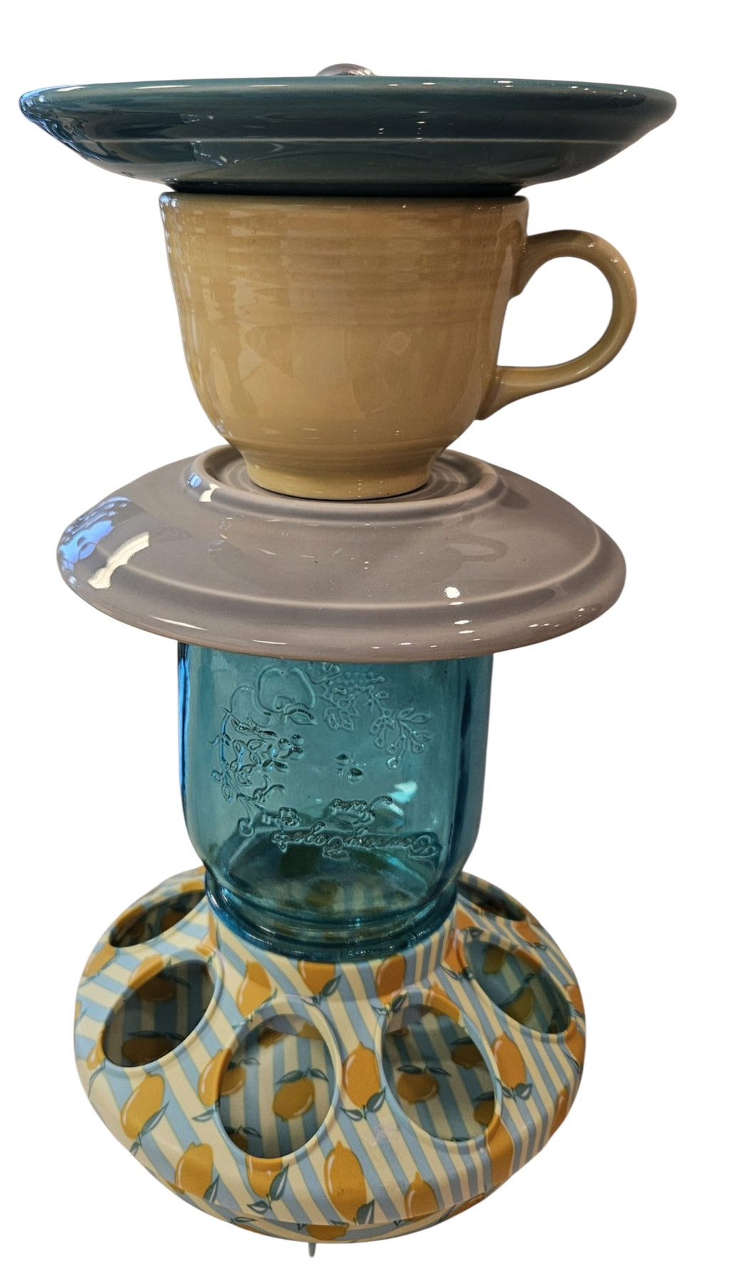 This is a handcrafted Birdfeeder made from a Fiesta Fiestware Cup and two saucers. It includes a glass jar to hold birdseed and either a plastic or metal base for the birds to land and feast. The top saucer is also perfect to hold grape jam or orange slices to feed your local orioles. Please see item description for specific cup and saucer color, jar color and base type. Crafted, Fiesta Second Life
