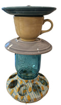 This is a handcrafted Birdfeeder made from a Fiesta Fiestware Cup and two saucers. It includes a glass jar to hold birdseed and either a plastic or metal base for the birds to land and feast. The top saucer is also perfect to hold grape jam or orange slices to feed your local orioles. Please see item description for specific cup and saucer color, jar color and base type. Crafted, Fiesta Second Life
