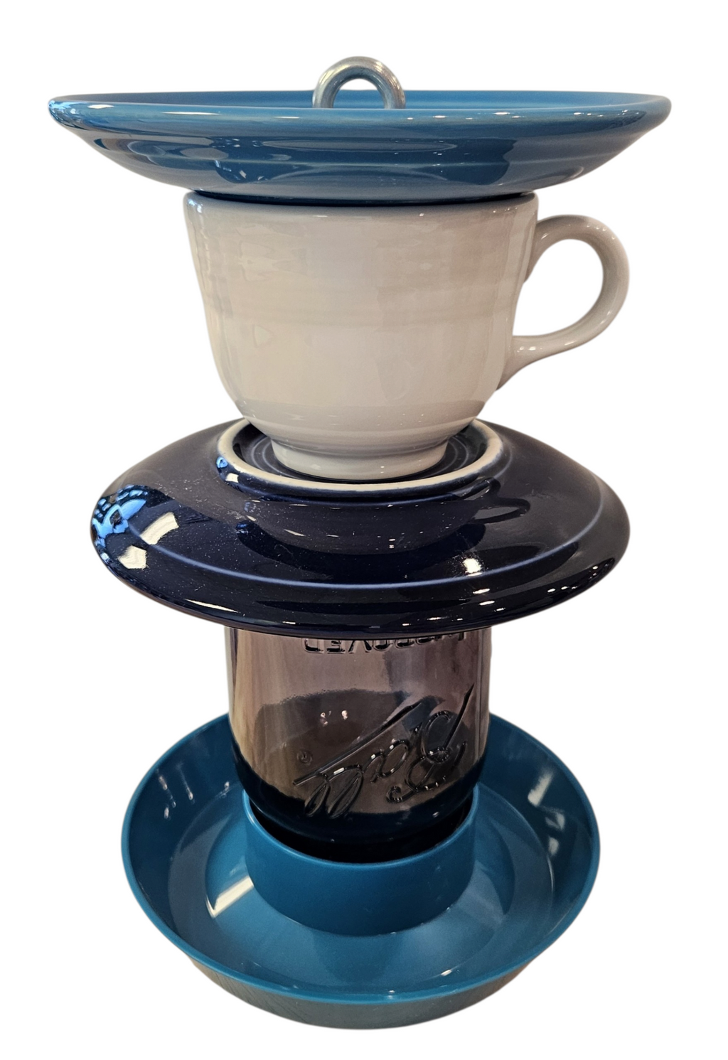 This is a handcrafted Birdfeeder made from a Fiesta Fiestware Cup and two saucers. It includes a glass jar to hold birdseed and either a plastic or metal base for the birds to land and feast. The top saucer is also perfect to hold grape jam or orange slices to feed your local orioles. Please see item description for specific cup and saucer color, jar color and base type. Crafted, Fiesta Second Life
