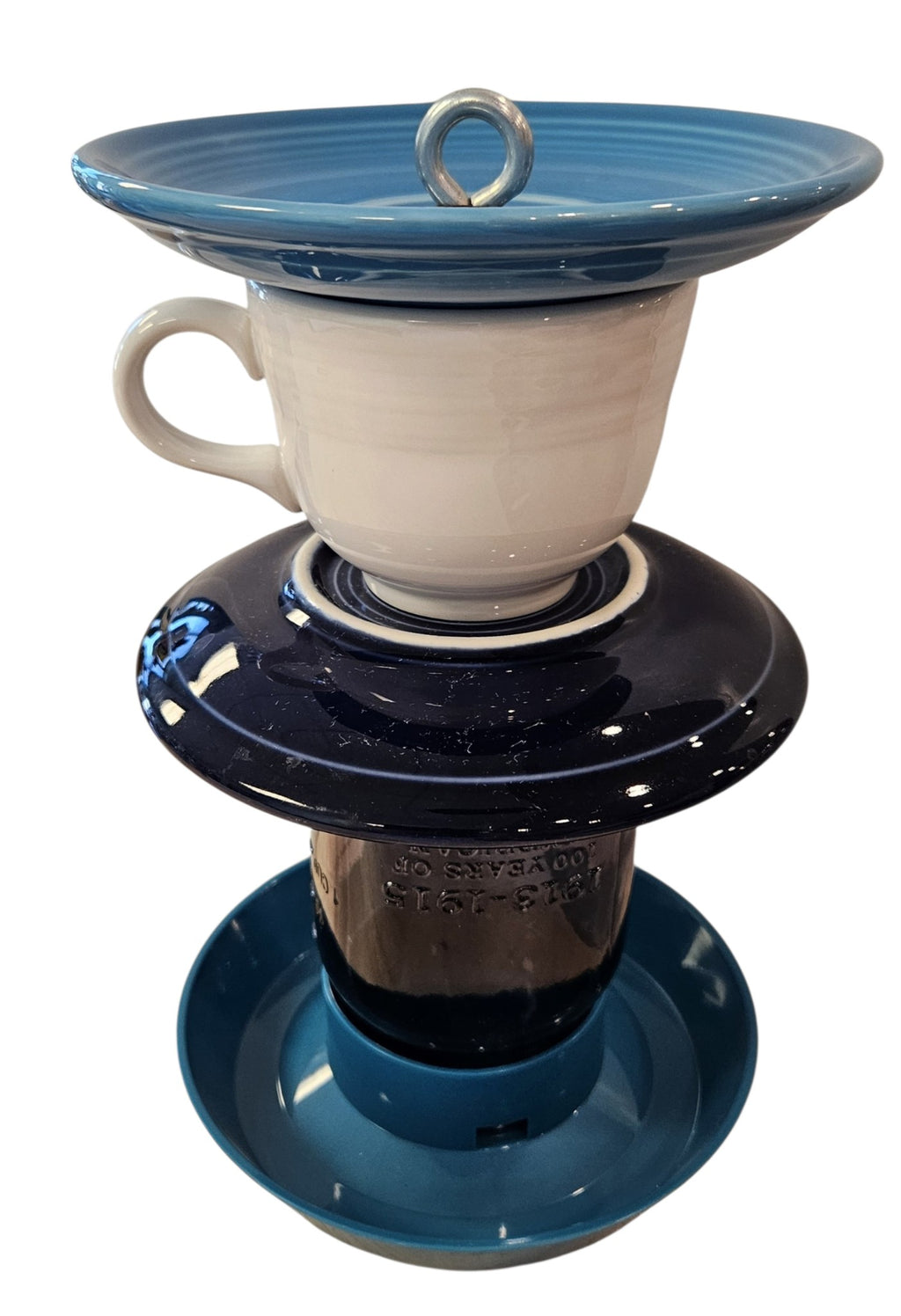 This is a handcrafted Birdfeeder made from a Fiesta Fiestware Cup and two saucers. It includes a glass jar to hold birdseed and either a plastic or metal base for the birds to land and feast. The top saucer is also perfect to hold grape jam or orange slices to feed your local orioles. Please see item description for specific cup and saucer color, jar color and base type. Crafted, Fiesta Second Life
