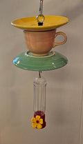 This is a handcrafted Hummingbird Feeder made from a Fiesta Fiestware Cup and two saucers. It includes a plastic nectar holder. While not included but shown in additional pictures, these can be used to hold chimes, a windsock, or other decoration. Please see item description for specific cup and saucer color.  Crafted, Fiesta Second Life
