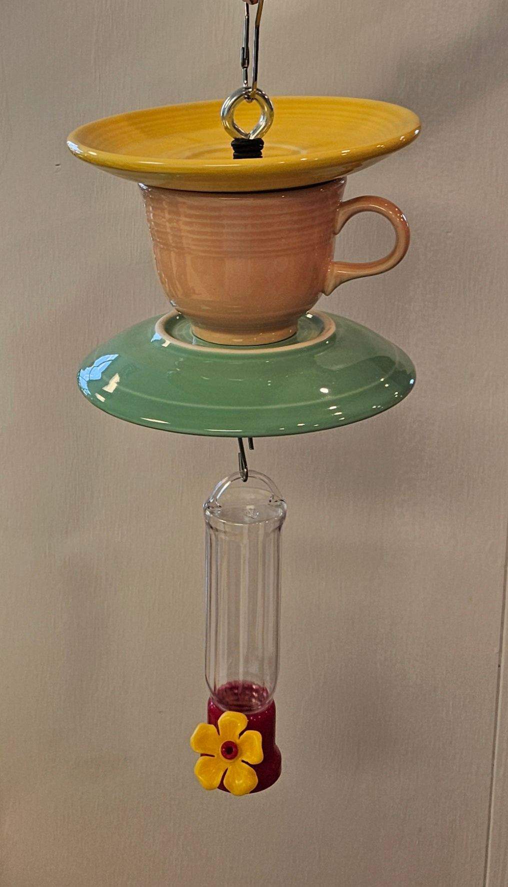 This is a handcrafted Hummingbird Feeder made from a Fiesta Fiestware Cup and two saucers. It includes a plastic nectar holder. While not included but shown in additional pictures, these can be used to hold chimes, a windsock, or other decoration. Please see item description for specific cup and saucer color.  Crafted, Fiesta Second Life
