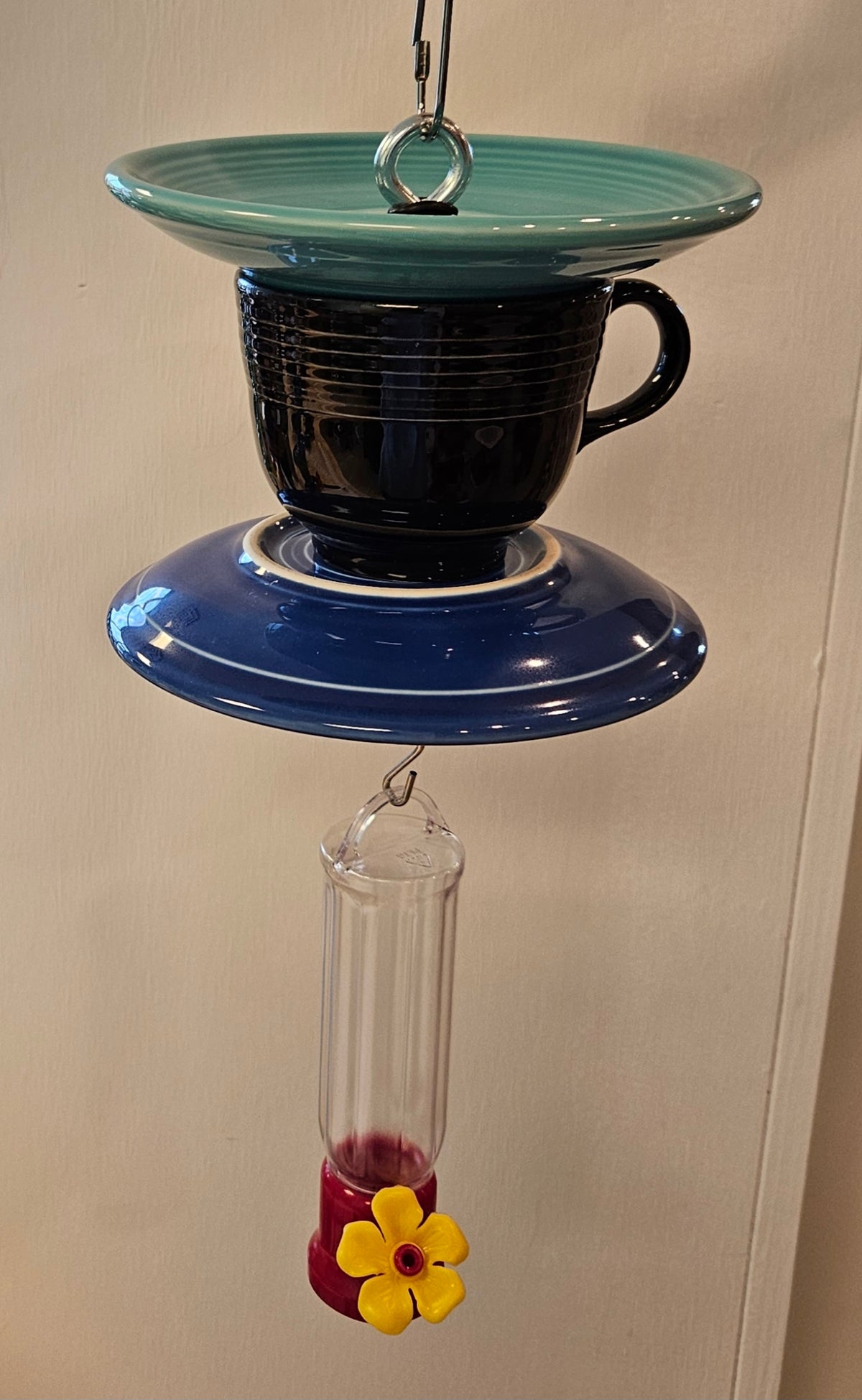 This is a handcrafted Hummingbird Feeder made from a Fiesta Fiestware Cup and two saucers. It includes a plastic nectar holder. While not included but shown in additional pictures, these can be used to hold chimes, a windsock, or other decoration. Please see item description for specific cup and saucer color.  Crafted, Fiesta Second Life
