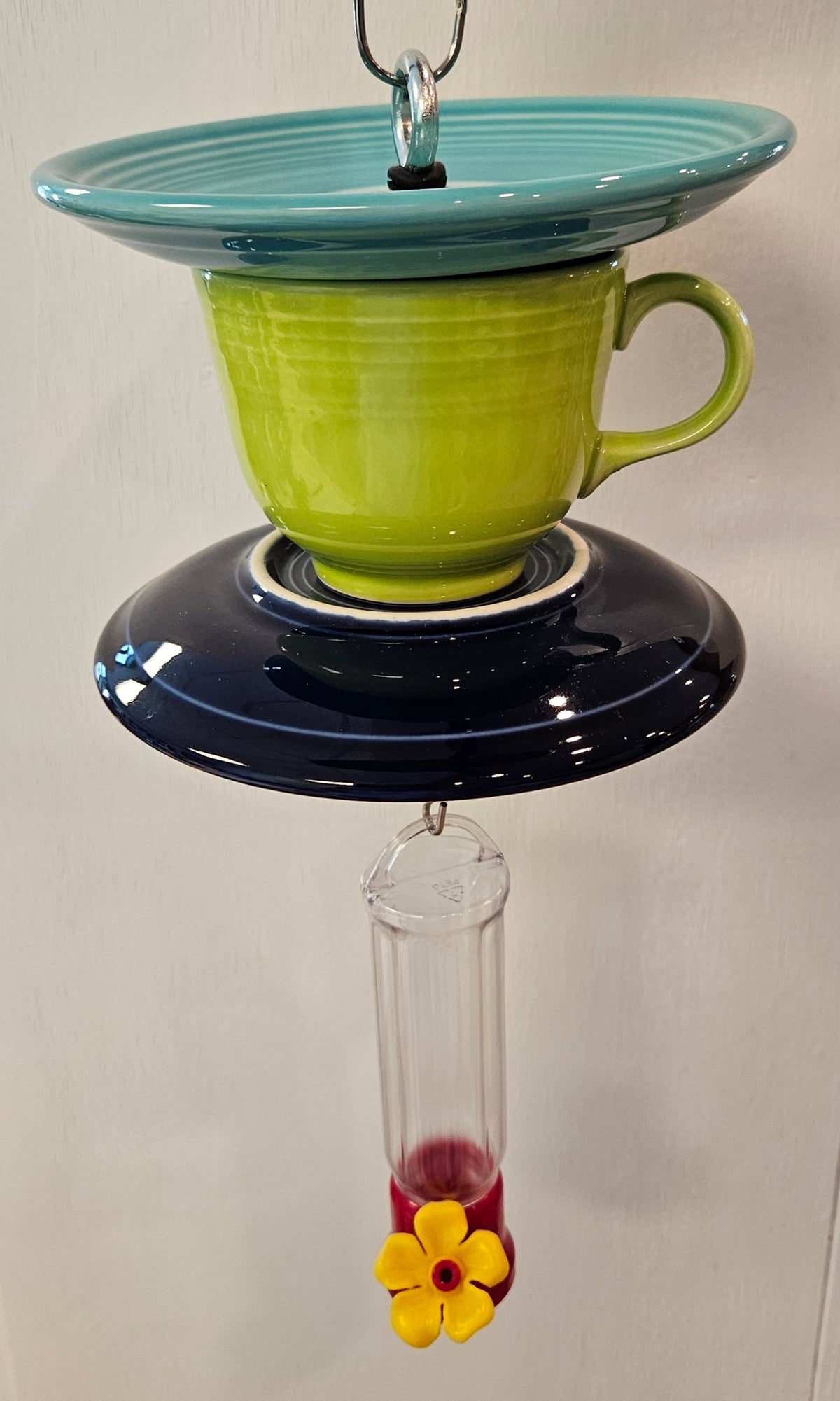 This is a handcrafted Hummingbird Feeder made from a Fiesta Fiestware Cup and two saucers. It includes a plastic nectar holder. While not included but shown in additional pictures, these can be used to hold chimes, a windsock, or other decoration. Please see item description for specific cup and saucer color.  Crafted, Fiesta Second Life
