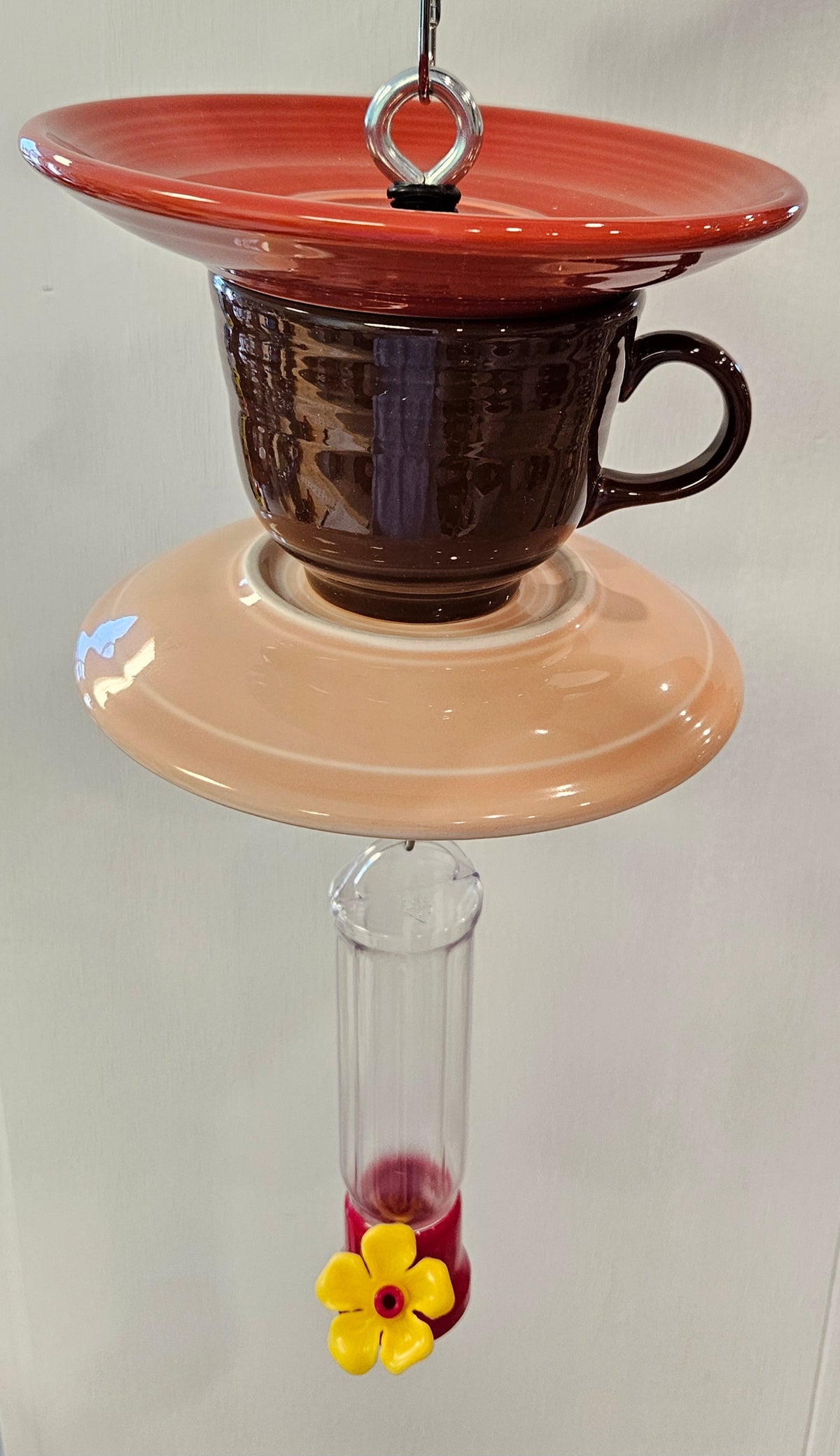 This is a handcrafted Hummingbird Feeder made from a Fiesta Fiestware Cup and two saucers. It includes a plastic nectar holder. While not included but shown in additional pictures, these can be used to hold chimes, a windsock, or other decoration. Please see item description for specific cup and saucer color.  Crafted, Fiesta Second Life
