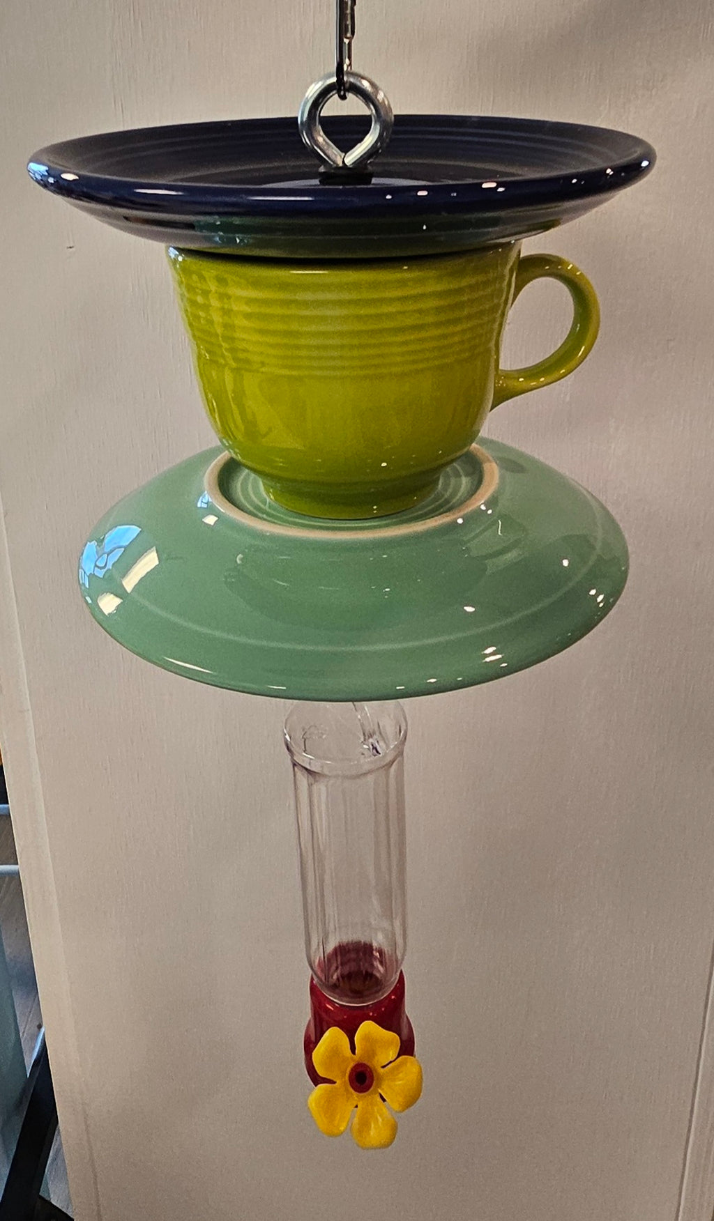 This is a handcrafted Hummingbird Feeder made from a Fiesta Fiestware Cup and two saucers. It includes a plastic nectar holder. While not included but shown in additional pictures, these can be used to hold chimes, a windsock, or other decoration. Please see item description for specific cup and saucer color.  Crafted, Fiesta Second Life
