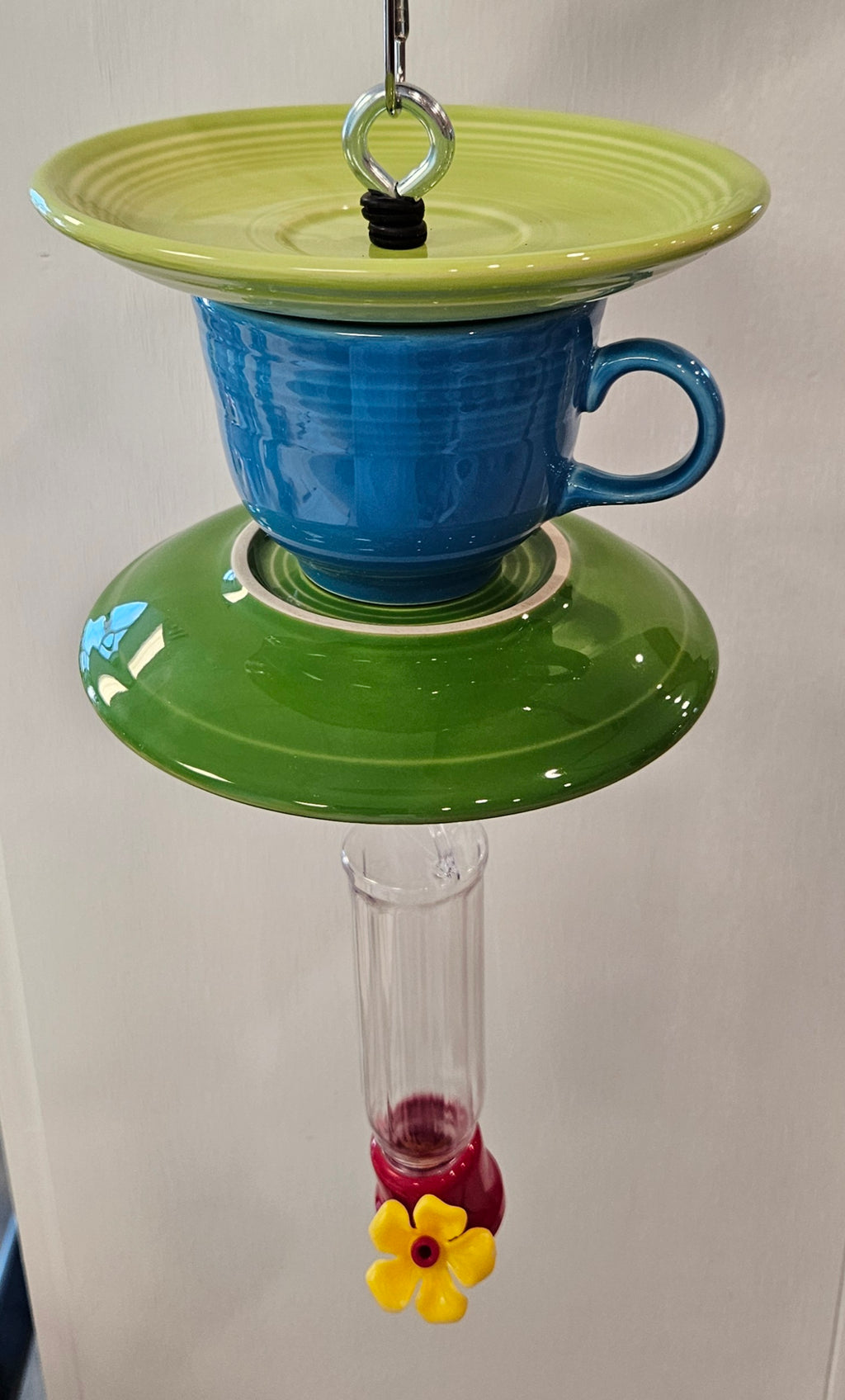 This is a handcrafted Hummingbird Feeder made from a Fiesta Fiestware Cup and two saucers. It includes a plastic nectar holder. While not included but shown in additional pictures, these can be used to hold chimes, a windsock, or other decoration. Please see item description for specific cup and saucer color.  Crafted, Fiesta Second Life
