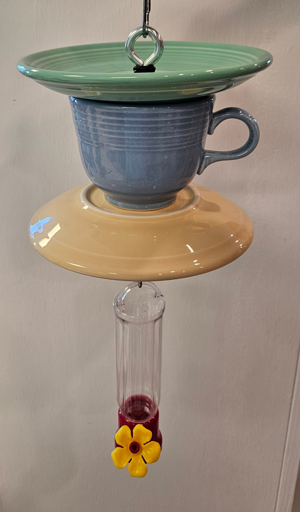 This is a handcrafted Hummingbird Feeder made from a Fiesta Fiestware Cup and two saucers. It includes a plastic nectar holder. While not included but shown in additional pictures, these can be used to hold chimes, a windsock, or other decoration. Please see item description for specific cup and saucer color.  Crafted, Fiesta Second Life
