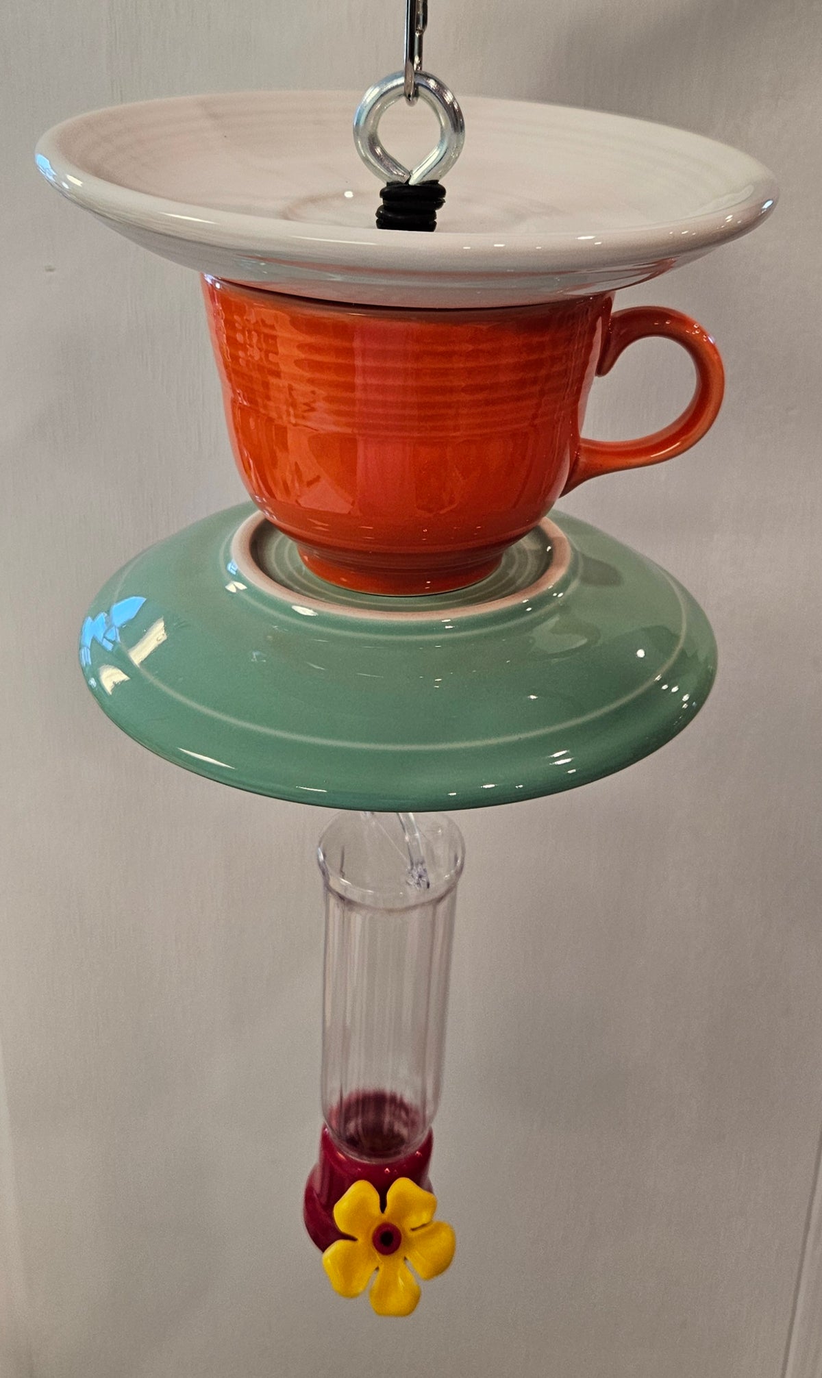 This is a handcrafted Hummingbird Feeder made from a Fiesta Fiestware Cup and two saucers. It includes a plastic nectar holder. While not included but shown in additional pictures, these can be used to hold chimes, a windsock, or other decoration. Please see item description for specific cup and saucer color.  Crafted, Fiesta Second Life
