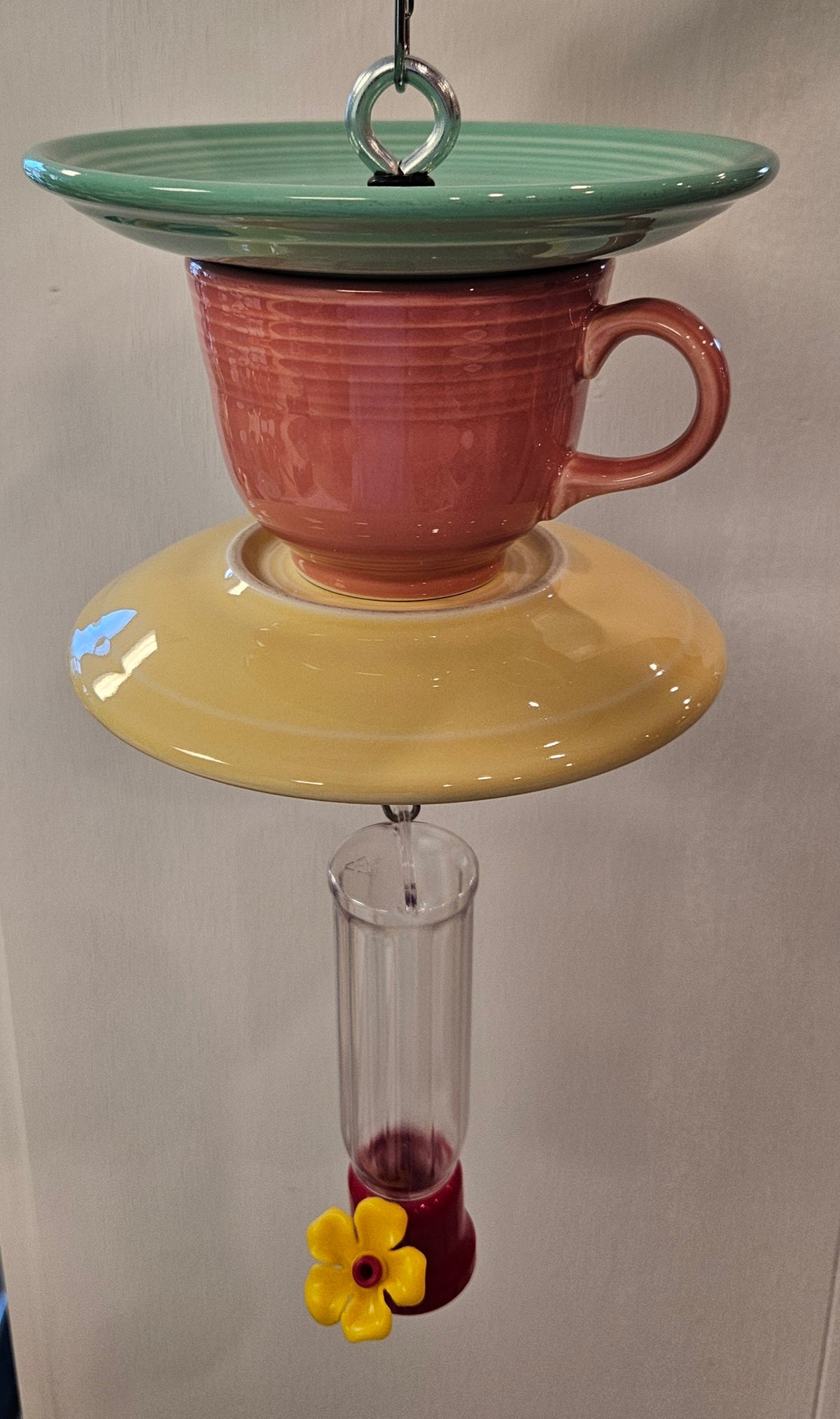 This is a handcrafted Hummingbird Feeder made from a Fiesta Fiestware Cup and two saucers. It includes a plastic nectar holder. While not included but shown in additional pictures, these can be used to hold chimes, a windsock, or other decoration. Please see item description for specific cup and saucer color.  Crafted, Fiesta Second Life
