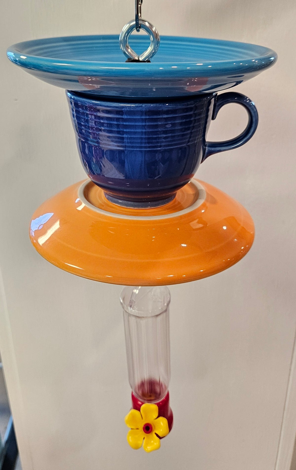 This is a handcrafted Hummingbird Feeder made from a Fiesta Fiestware Cup and two saucers. It includes a plastic nectar holder. While not included but shown in additional pictures, these can be used to hold chimes, a windsock, or other decoration. Please see item description for specific cup and saucer color.  Crafted, Fiesta Second Life
