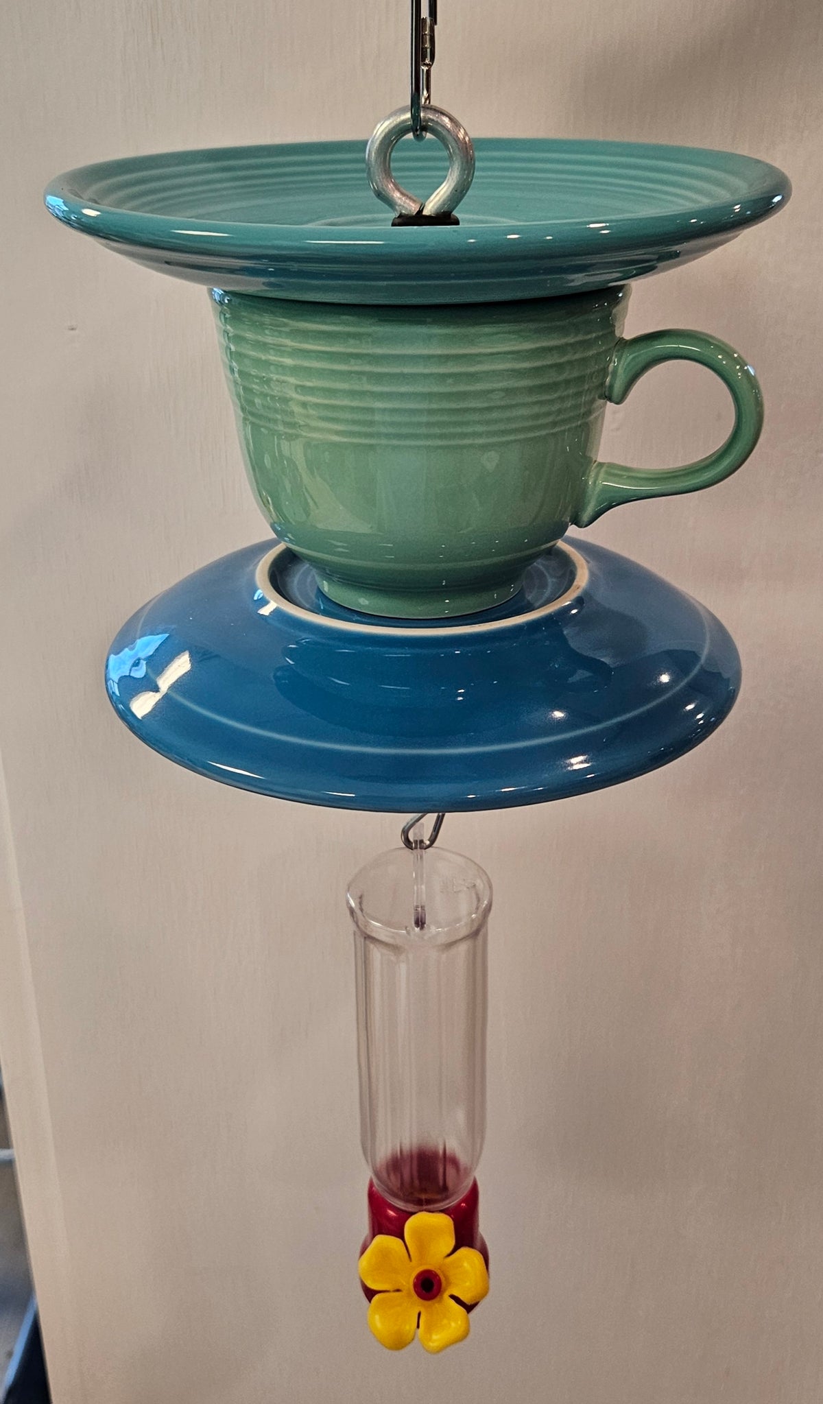This is a handcrafted Hummingbird Feeder made from a Fiesta Fiestware Cup and two saucers. It includes a plastic nectar holder. While not included but shown in additional pictures, these can be used to hold chimes, a windsock, or other decoration. Please see item description for specific cup and saucer color.  Crafted, Fiesta Second Life
