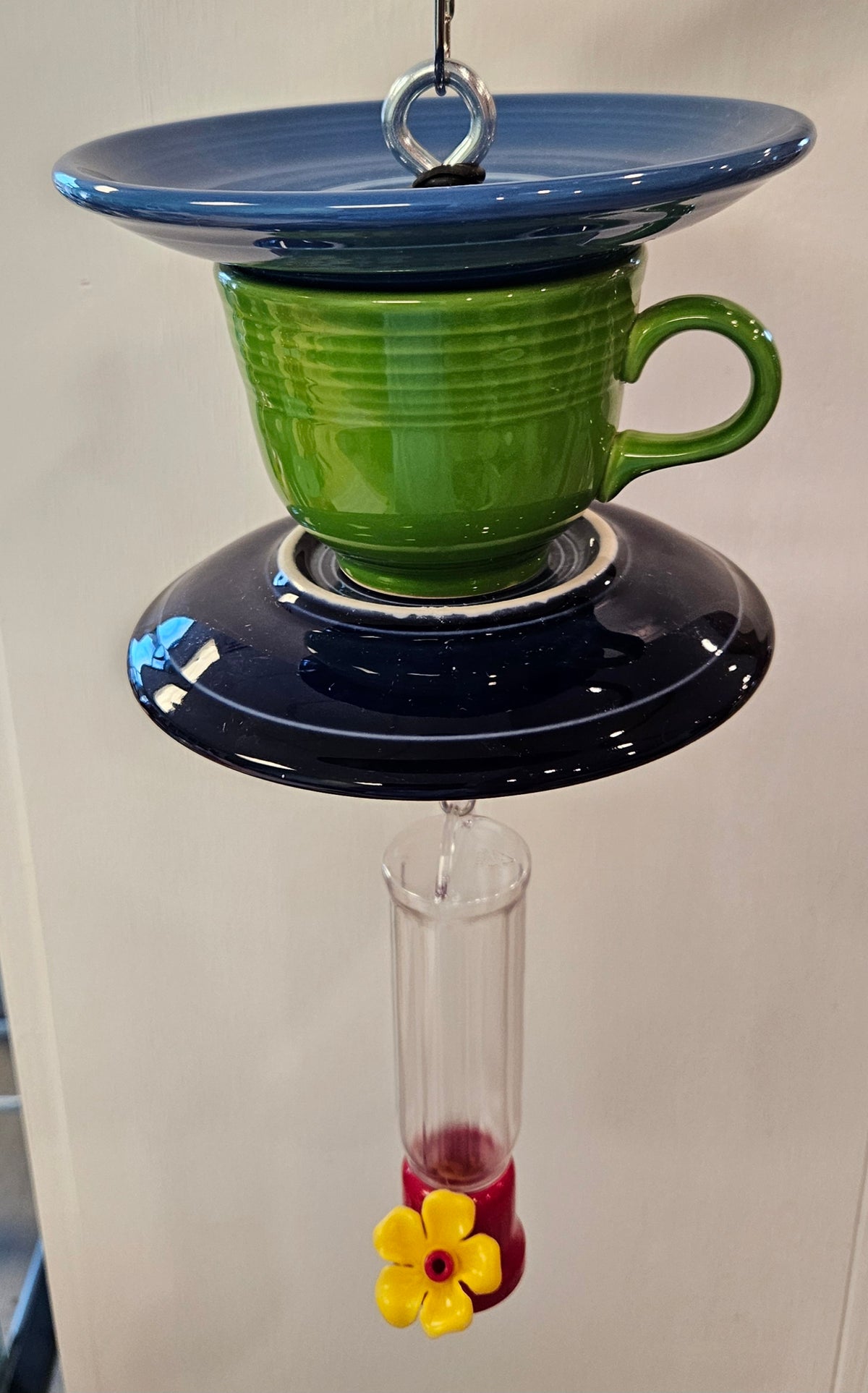 This is a handcrafted Hummingbird Feeder made from a Fiesta Fiestware Cup and two saucers. It includes a plastic nectar holder. While not included but shown in additional pictures, these can be used to hold chimes, a windsock, or other decoration. Please see item description for specific cup and saucer color.  Crafted, Fiesta Second Life
