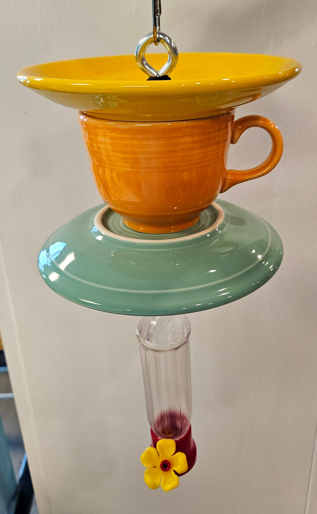 This is a handcrafted Hummingbird Feeder made from a Fiesta Fiestware Cup and two saucers. It includes a plastic nectar holder. While not included but shown in additional pictures, these can be used to hold chimes, a windsock, or other decoration. Please see item description for specific cup and saucer color.  Crafted, Fiesta Second Life
