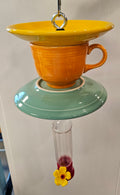 This is a handcrafted Hummingbird Feeder made from a Fiesta Fiestware Cup and two saucers. It includes a plastic nectar holder. While not included but shown in additional pictures, these can be used to hold chimes, a windsock, or other decoration. Please see item description for specific cup and saucer color.  Crafted, Fiesta Second Life
