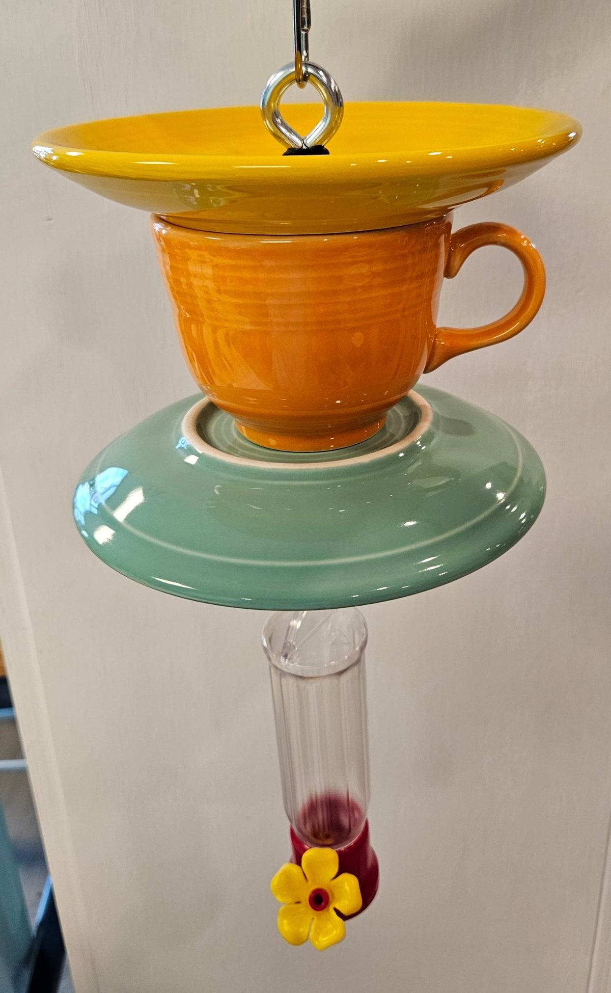 This is a handcrafted Hummingbird Feeder made from a Fiesta Fiestware Cup and two saucers. It includes a plastic nectar holder. While not included but shown in additional pictures, these can be used to hold chimes, a windsock, or other decoration. Please see item description for specific cup and saucer color.  Crafted, Fiesta Second Life
