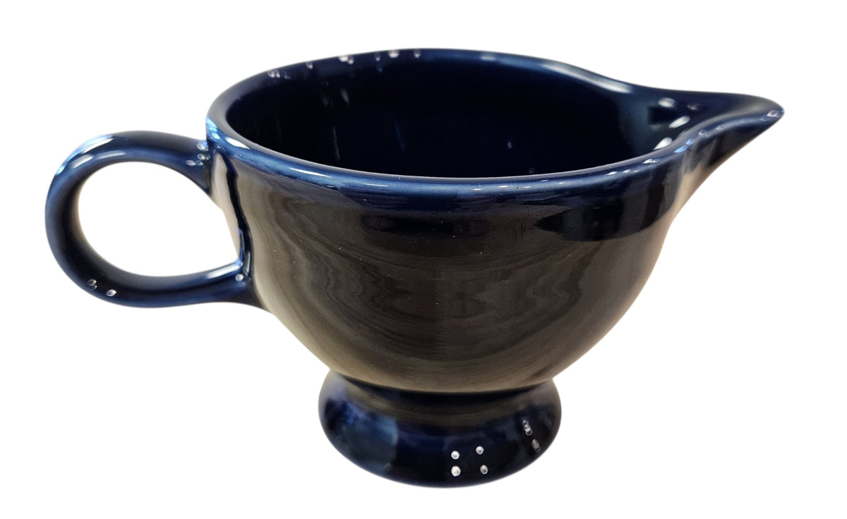 This is a Fiesta Fiestaware individual cream pitcher creamer in Plum. lead-free, Post 1986, Retired Color Retired Shape
