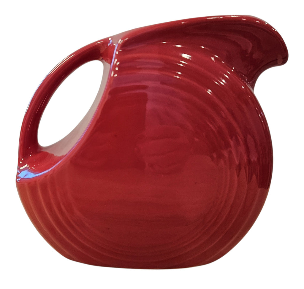 This is a Fiesta Fiestaware Small Disc Juice Pitcher in scarlet. lead-free, Post 1986, Retired Shape 28 ounce capacity
