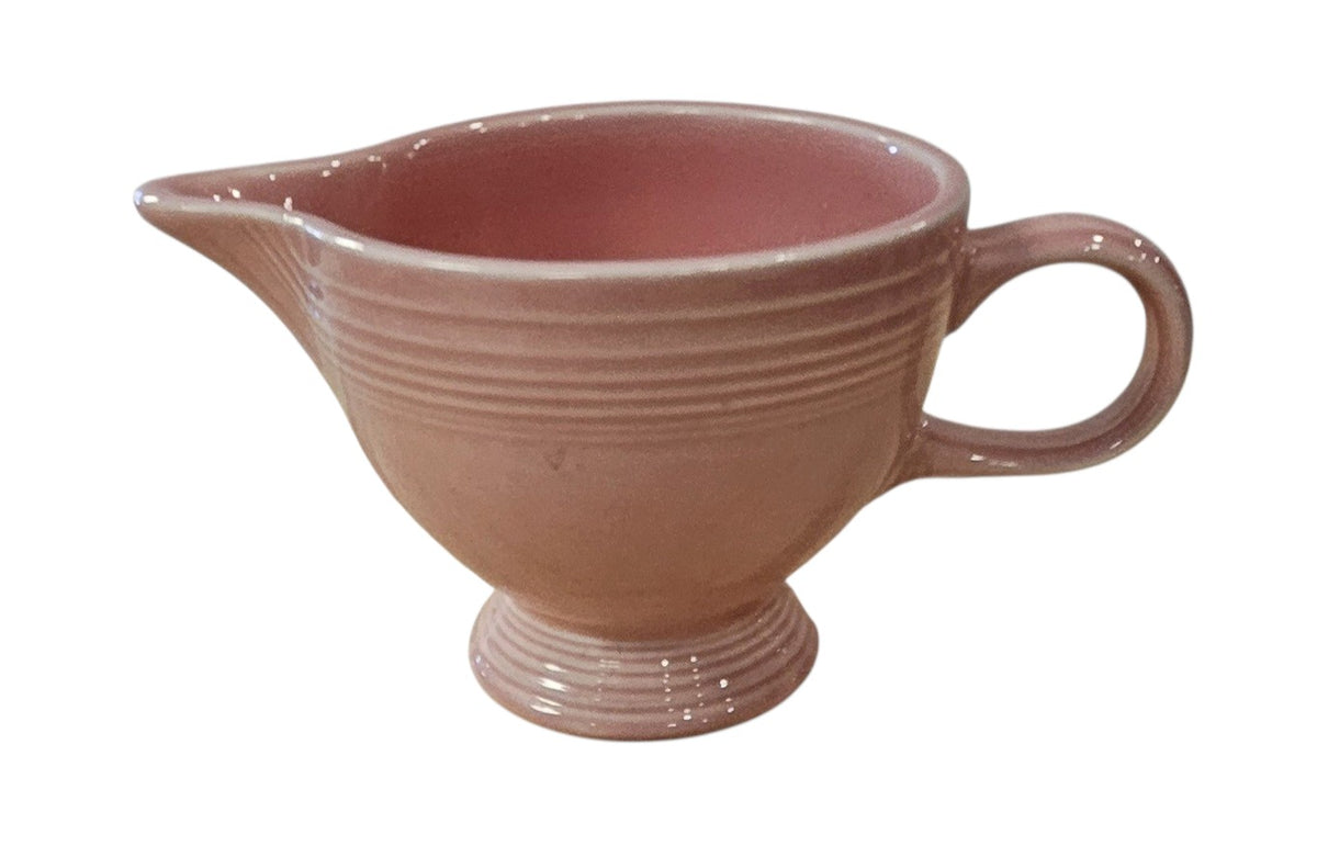 This is a Fiesta Fiestaware individual cream pitcher creamer in Rose. lead-free, Post 1986, Retired Color Retired Shape
