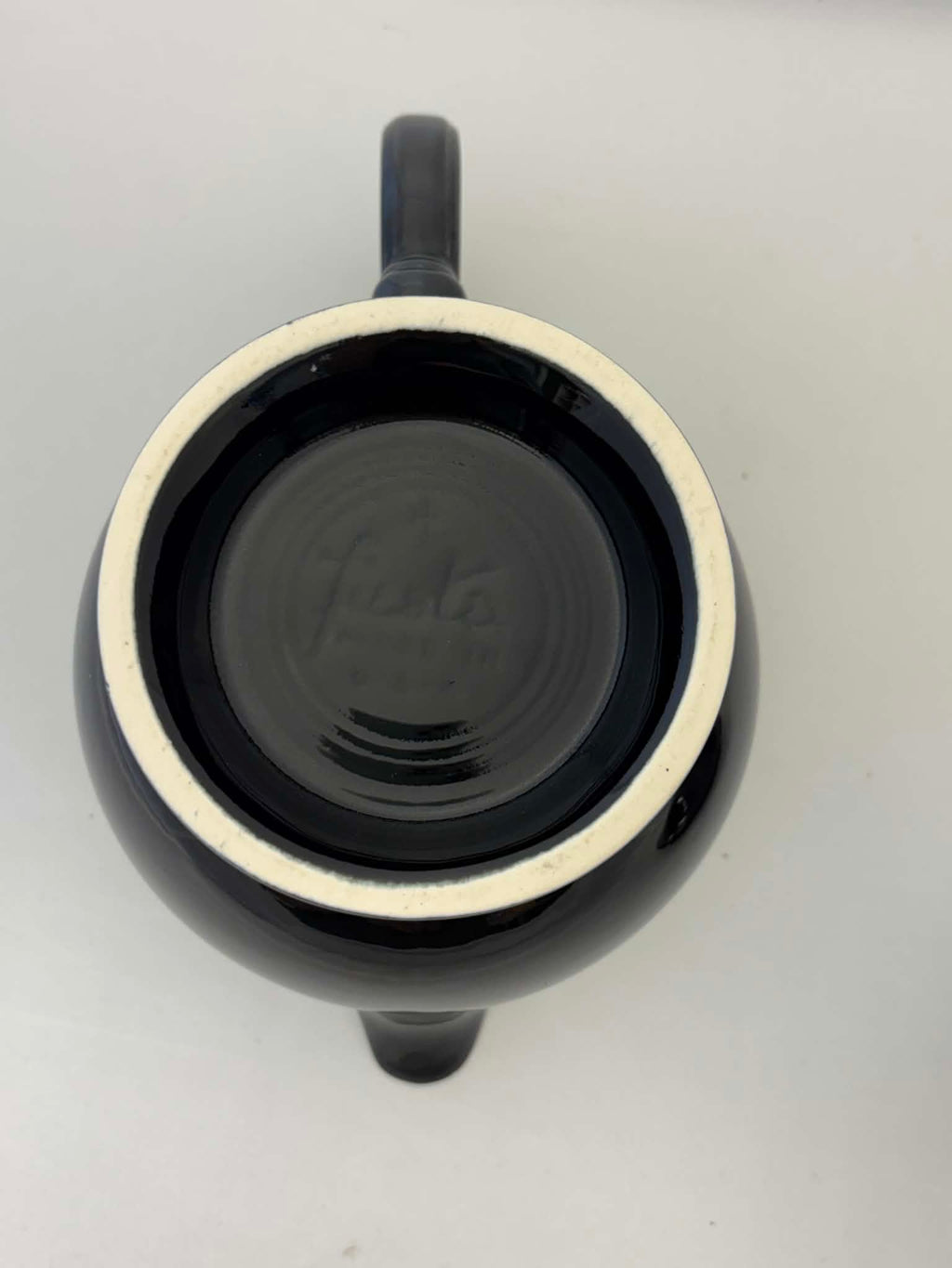 This is a Fiesta Fiestaware Five-cup 5-cup Ring Handled Tea Pot with Lid in Black. lead-free, Post 1986, Retired Color Retired Shape
