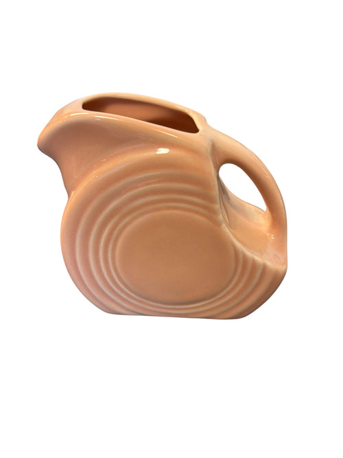 This is a Fiesta Fiestaware Mini Disc Pitcher Creamer in Apricot. lead-free, Post 1986, Retired Color 5 ounce