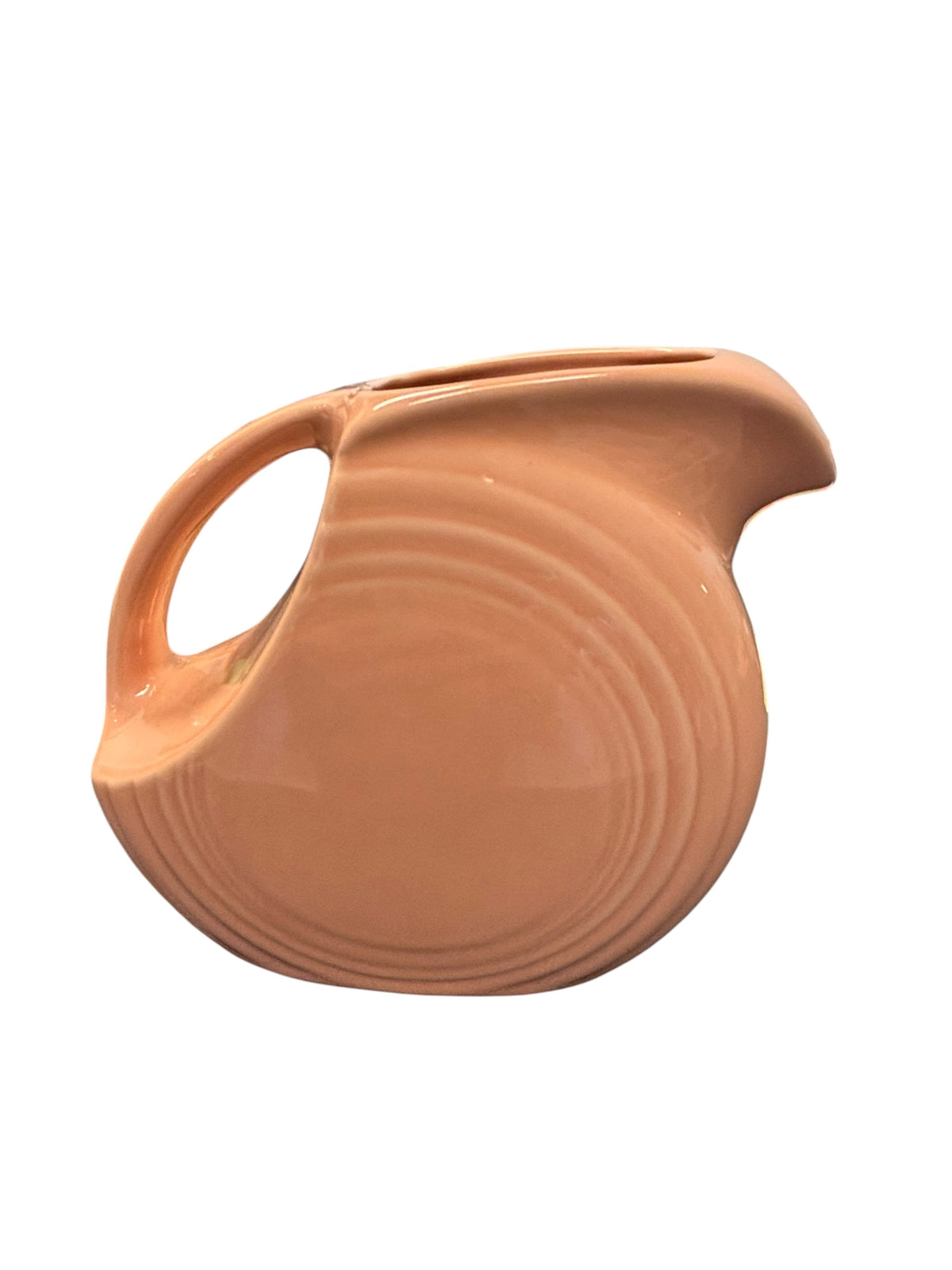 This is a Fiesta Fiestaware Small Disc Juice Pitcher in Apricot. lead-free, Post 1986, Retired Color Retired Shape 28 ounce capacity