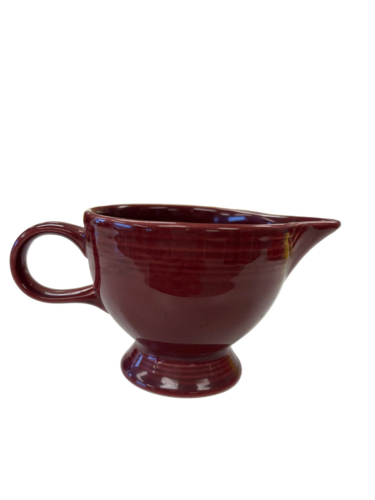 This is a Fiesta Fiestaware individual cream pitcher creamer in Cinnabar. lead-free, Post 1986, Retired Color Retired Shape
