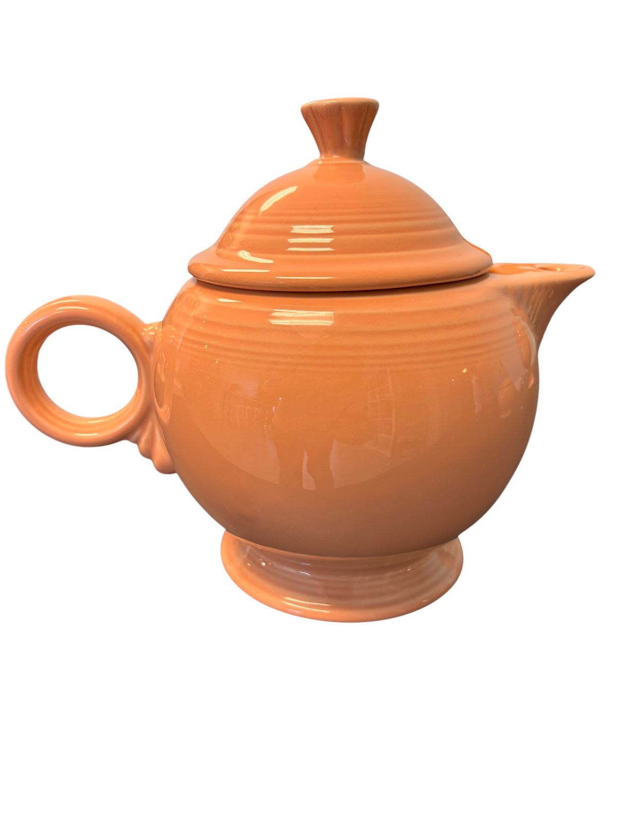 This is a Fiesta Fiestaware Five-cup 5-cup Ring Handled Tea Pot with Lid in Apricot. lead-free, Post 1986, Retired Color Retired Shape
