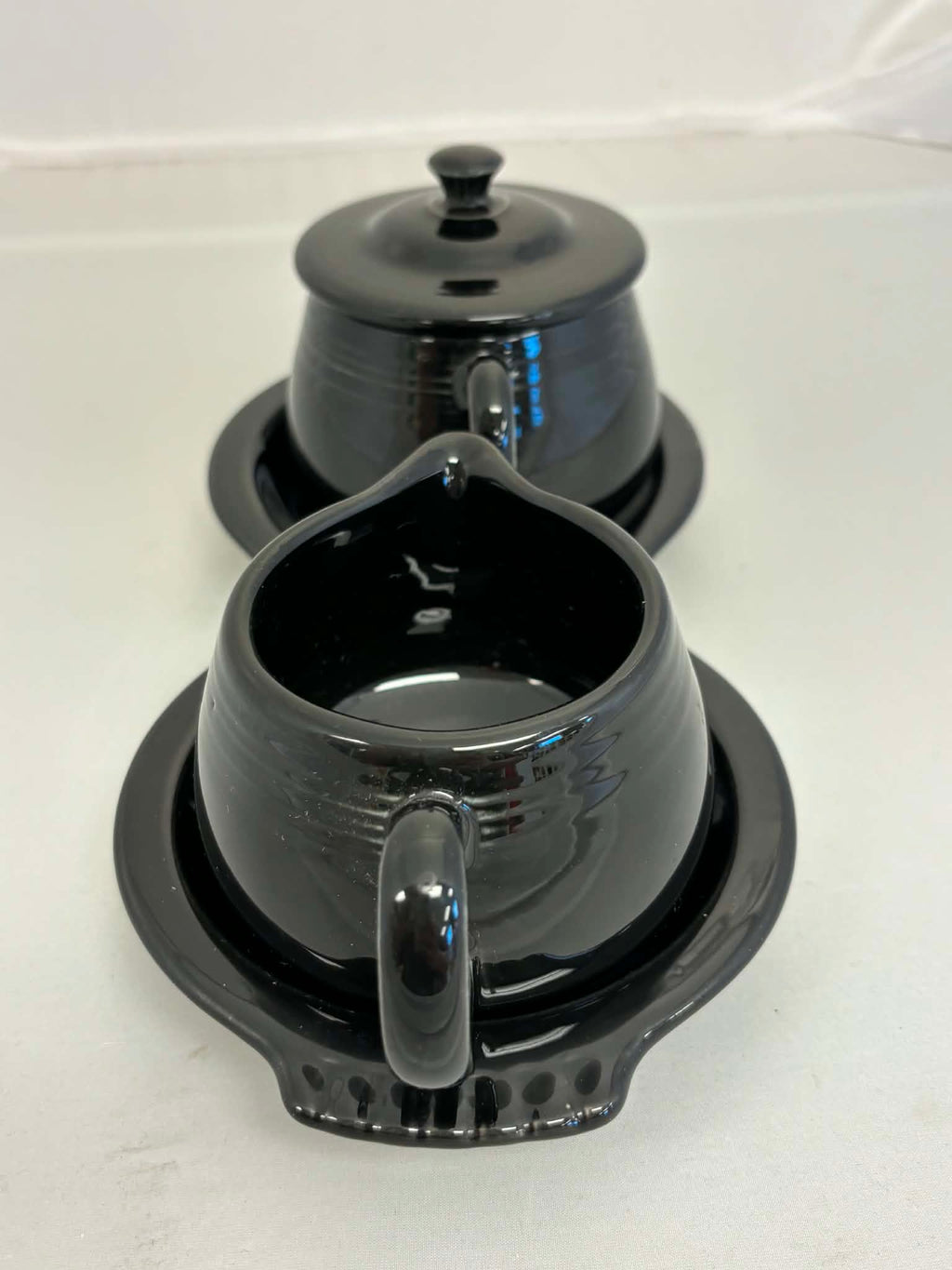 This is a Fiesta Fiestaware Creamer Pitcher Sugar Bowl with Lid on Figure Eight 8 Tray Set in black. lead-free, Post 1986, Retired Color Retired Shape

