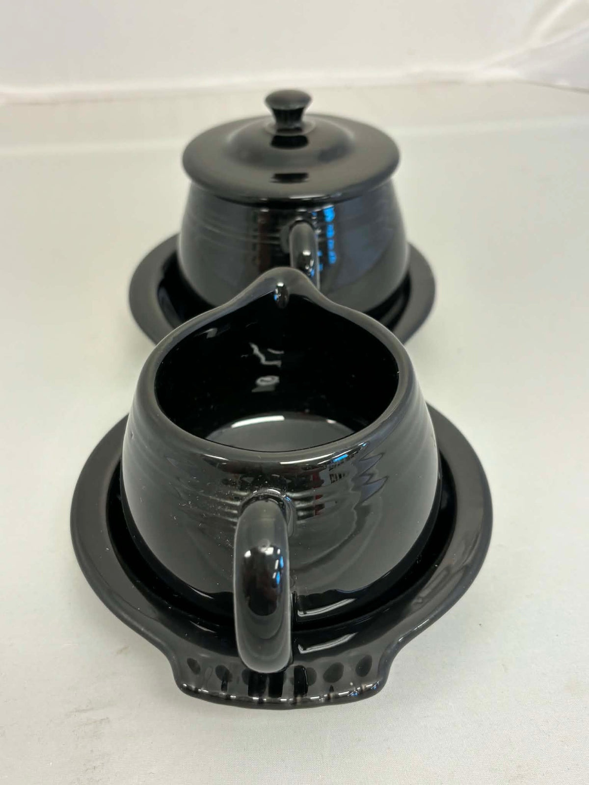 This is a Fiesta Fiestaware Creamer Pitcher Sugar Bowl with Lid on Figure Eight 8 Tray Set in black. lead-free, Post 1986, Retired Color Retired Shape
