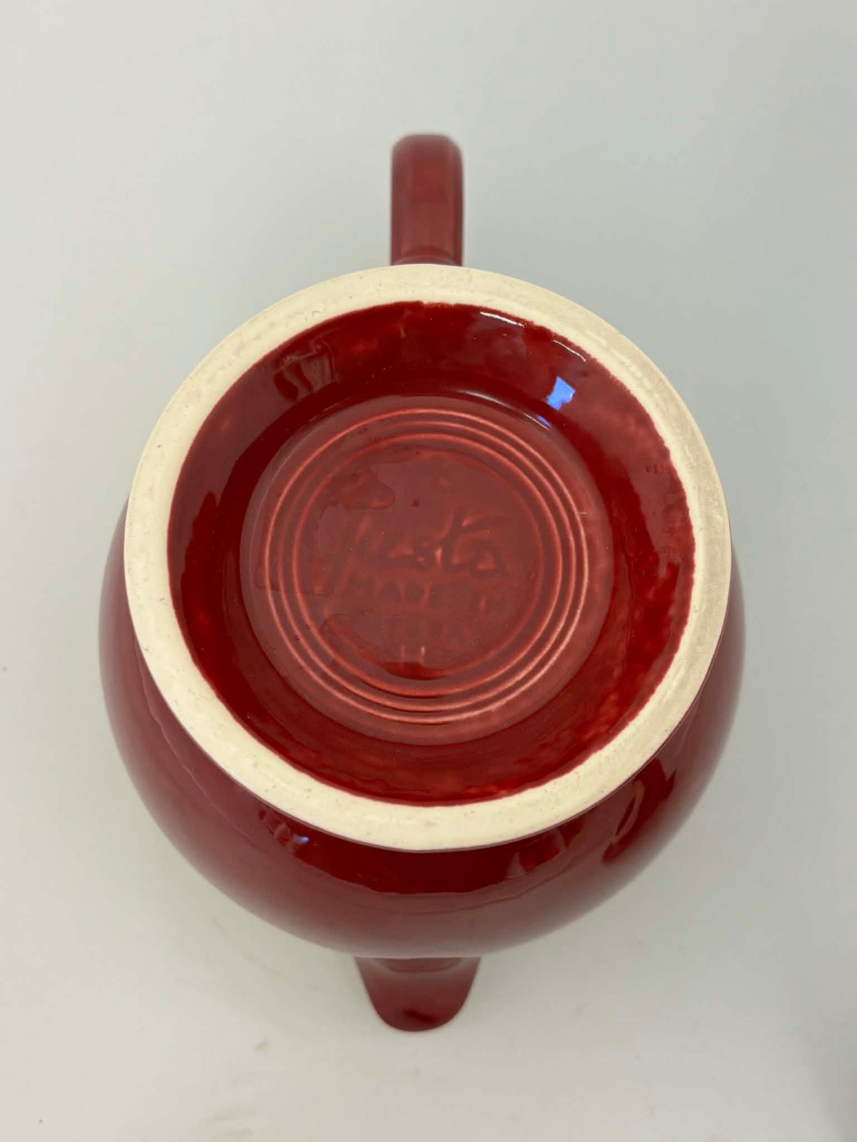 This is a Fiesta Fiestaware Five-cup 5-cup Ring Handled Tea Pot with Lid in Cinnabar. lead-free, Post 1986, Retired Color Retired Shape
