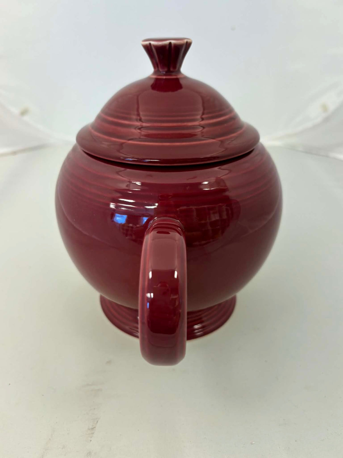This is a Fiesta Fiestaware Five-cup 5-cup Ring Handled Tea Pot with Lid in Cinnabar. lead-free, Post 1986, Retired Color Retired Shape

