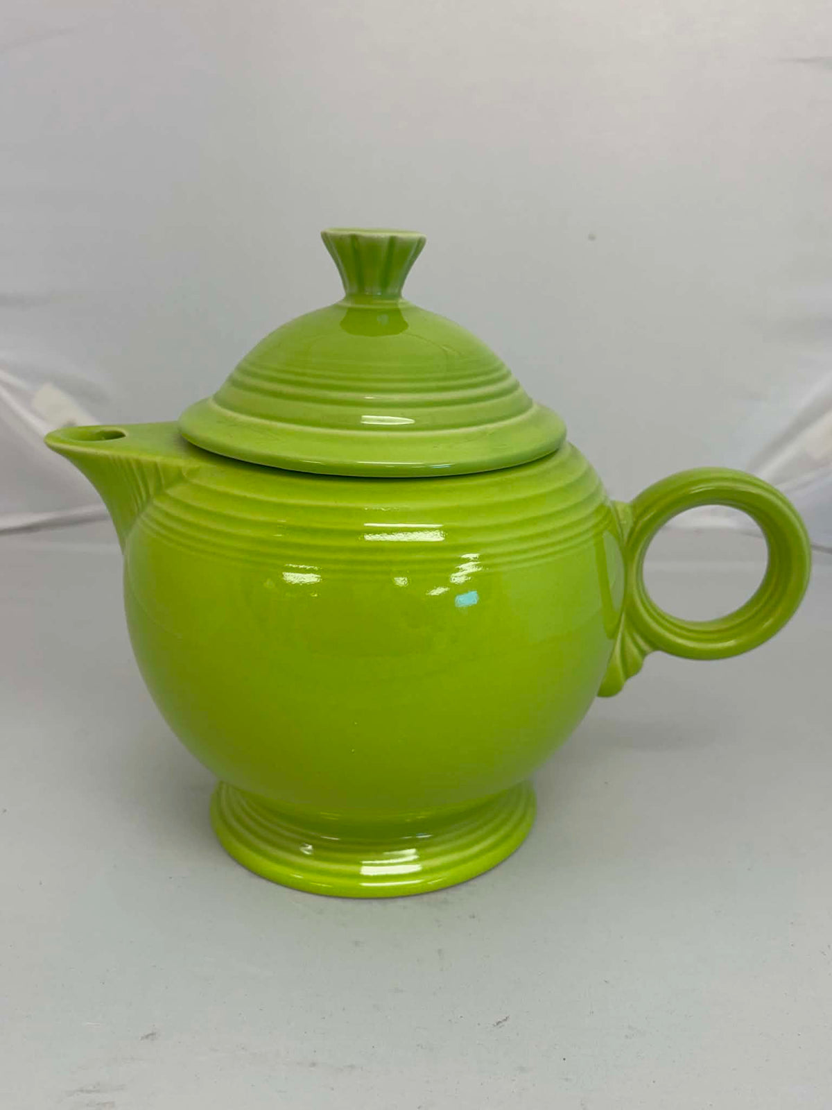 This is a Fiesta Fiestaware Five-cup 5-cup Ring Handled Tea Pot with Lid in Chartreuse. lead-free, Post 1986, Retired Color Retired Shape
