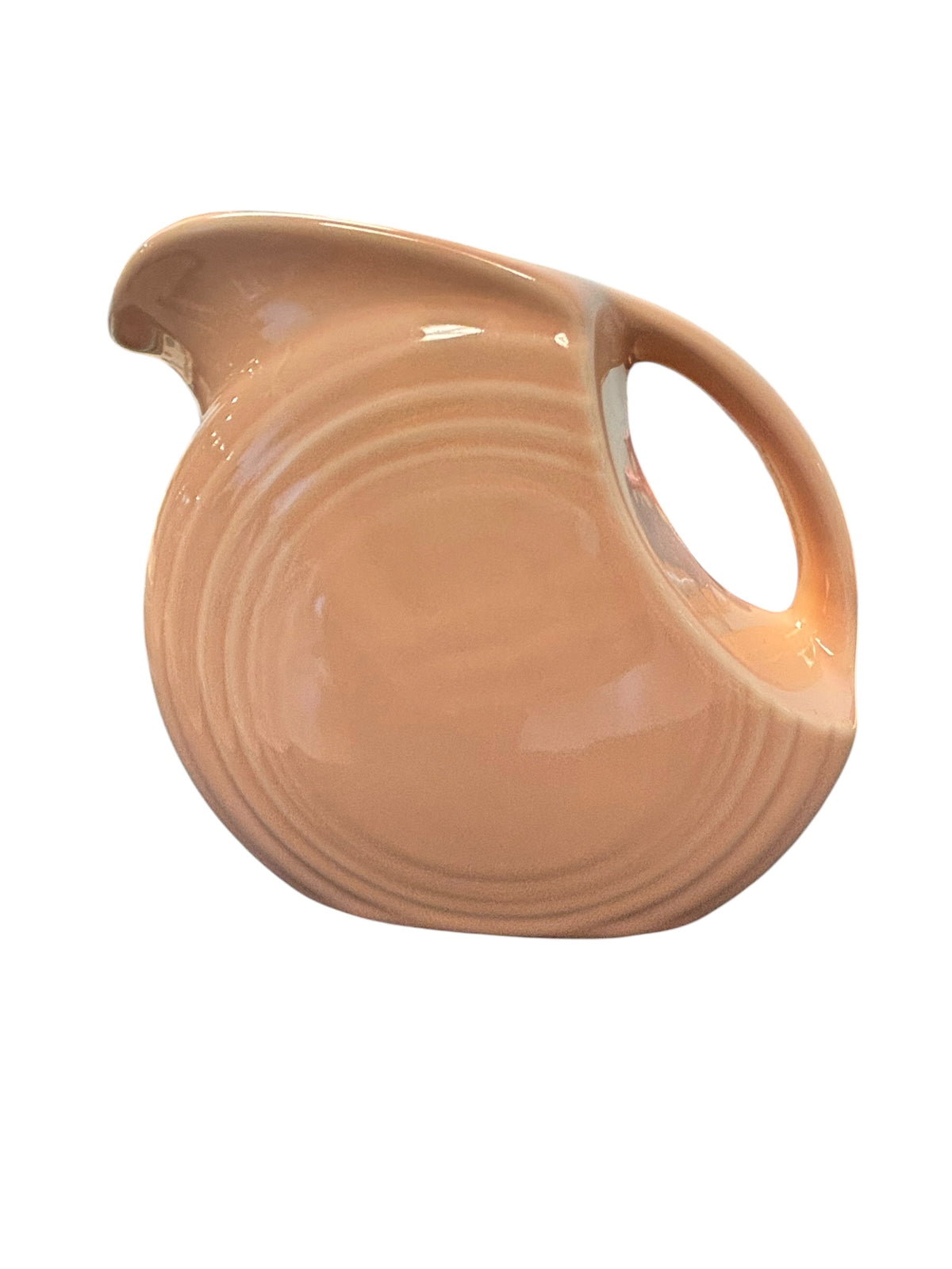 This is a Fiesta Fiestaware Small Disc Juice Pitcher in Apricot. lead-free, Post 1986, Retired Color Retired Shape 28 ounce capacity