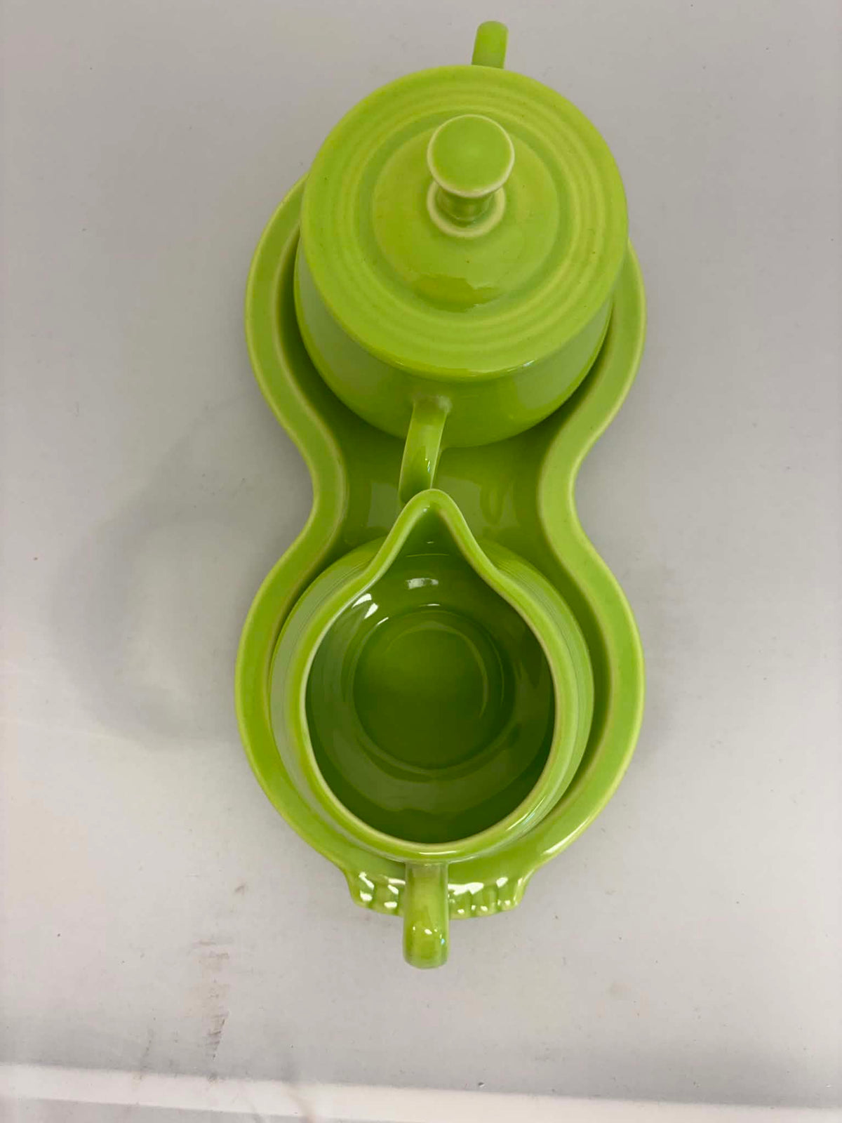 This is a Fiesta Fiestaware Creamer Pitcher Sugar Bowl with Lid on Figure Eight 8 Tray Set in chartreuse lead-free, Post 1986, Retired Color Retired Shape
