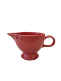 This is a Fiesta Fiestaware individual cream pitcher creamer in Flamingo. lead-free, Post 1986, Retired Color Retired Shape
