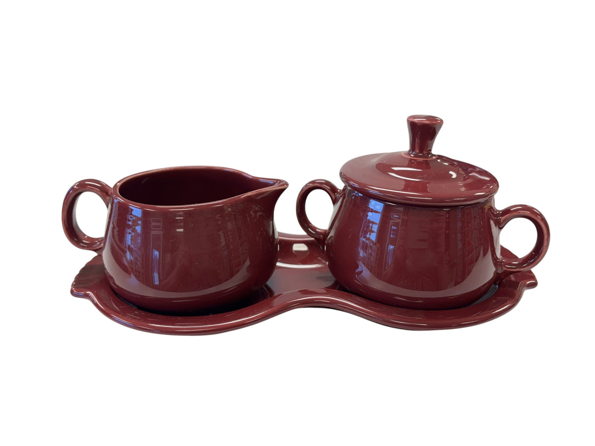 This is a Fiesta Fiestaware Creamer Pitcher Sugar Bowl with Lid on Figure Eight 8 Tray Set in cinnabar lead-free, Post 1986, Retired Color Retired Shape
