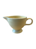 This is a Fiesta Fiestaware individual cream pitcher creamer in Yellow. lead-free, Post 1986, Retired Color Retired Shape
