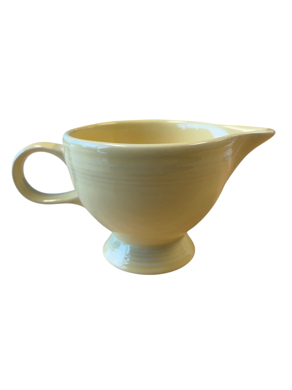 This is a Fiesta Fiestaware individual cream pitcher creamer in Yellow. lead-free, Post 1986, Retired Color Retired Shape
