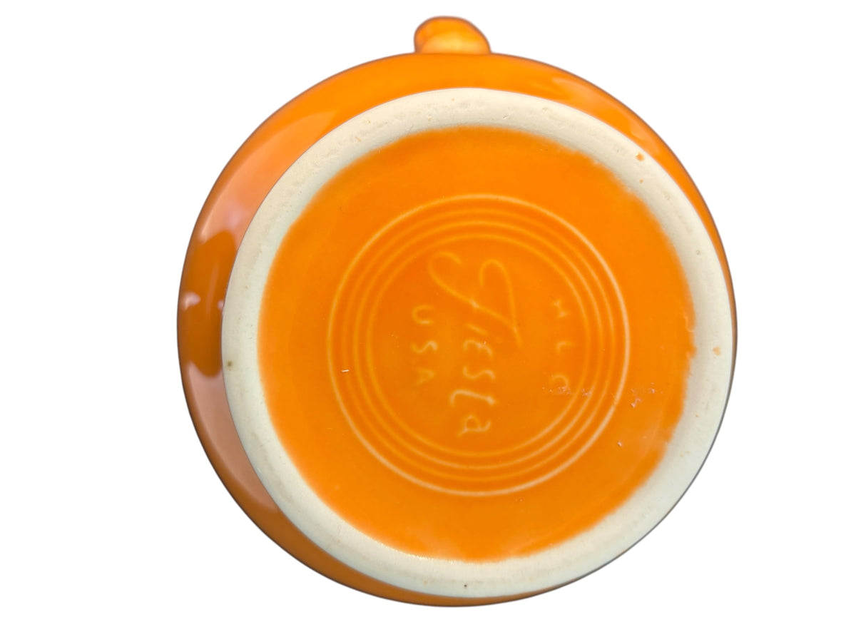 This is a Fiesta Fiestware small 60 Ounce Carafe in tangerine. Lead-free Post 1986 Retired color retired shape
