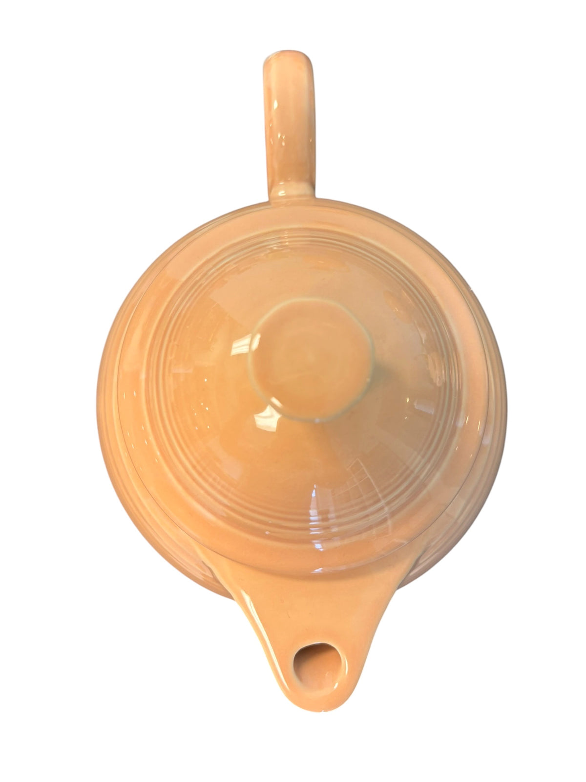 This is a Fiesta Fiestaware Five-cup 5-cup Ring Handled Tea Pot with Lid in Apricot. lead-free, Post 1986, Retired Color Retired Shape