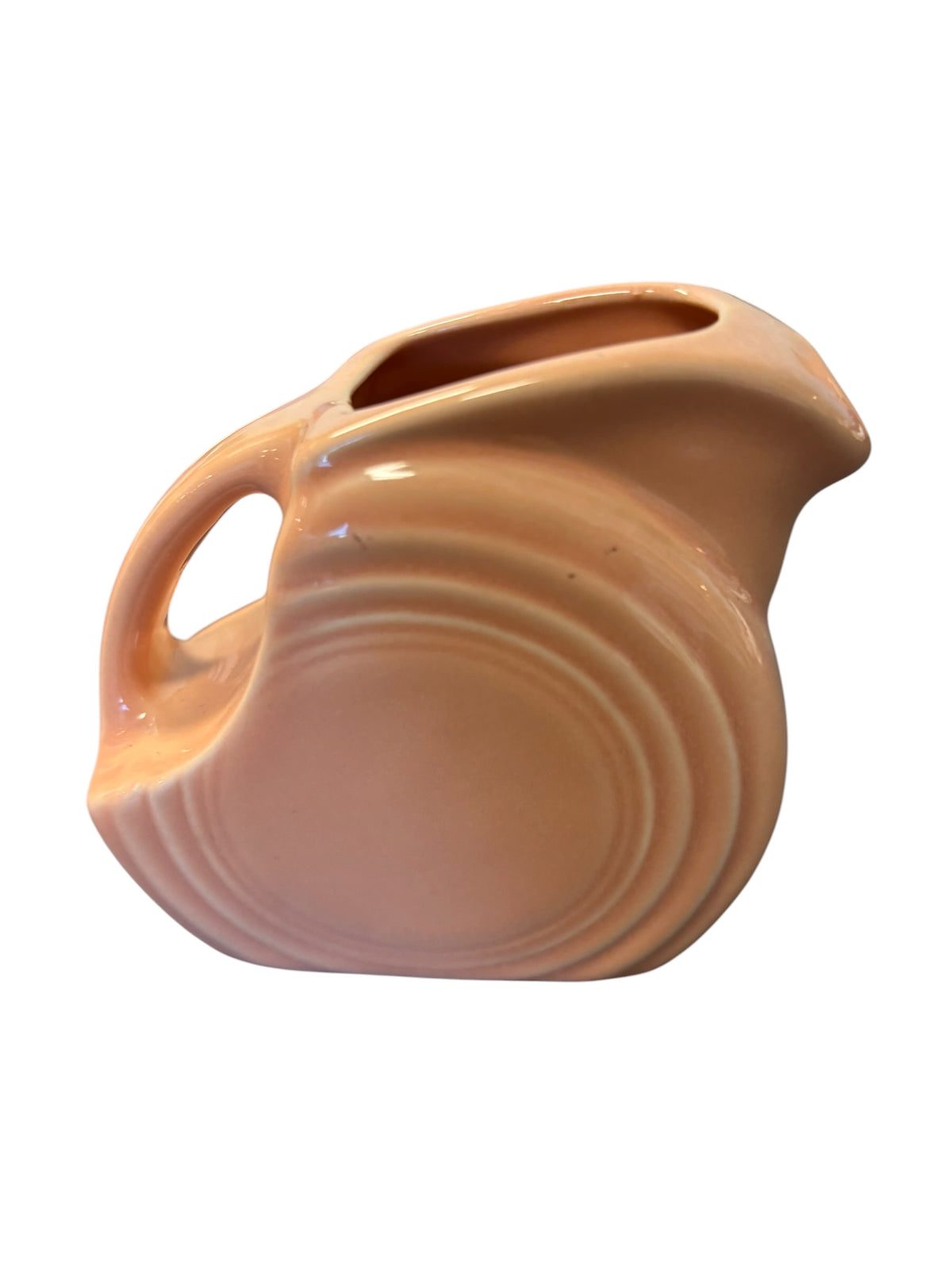 This is a Fiesta Fiestaware Mini Disc Pitcher Creamer in Apricot. lead-free, Post 1986, Retired Color 5 ounce