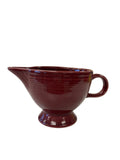This is a Fiesta Fiestaware individual cream pitcher creamer in Cinnabar. lead-free, Post 1986, Retired Color Retired Shape
